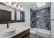 Modern bathroom features a unique vessel sink, stone-look tiling, and a shower-tub combo at 10455 Courageous Dr, Indianapolis, IN 46236