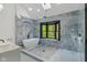 Stunning bathroom featuring a soaking tub and a glass enclosed shower with striking stone tile at 10455 Courageous Dr, Indianapolis, IN 46236
