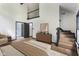 Bright bedroom with hardwood flooring, view of second story, stairs and modern furnishings at 10455 Courageous Dr, Indianapolis, IN 46236