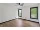 Light-filled bedroom showcasing hardwood floors and windows with black trim at 10455 Courageous Dr, Indianapolis, IN 46236