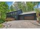 Two-story home with dark wood siding and a two-car garage on a sunny day at 10455 Courageous Dr, Indianapolis, IN 46236