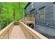 The side of the house features a ramp that leads to the front door, as well as windows and wood siding at 10455 Courageous Dr, Indianapolis, IN 46236