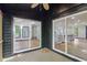Exterior view of sliding glass doors from back deck, showcasing bright interior and hardwood floors at 10455 Courageous Dr, Indianapolis, IN 46236