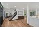 Inviting home foyer featuring sleek wooden floors and staircase leading to the upper level at 10455 Courageous Dr, Indianapolis, IN 46236