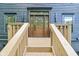 The front door of the home is a beautiful wooden door with a glass pane and a decorative frame at 10455 Courageous Dr, Indianapolis, IN 46236