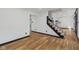 Spacious hallway featuring wood floors and view of the staircase and kitchen area at 10455 Courageous Dr, Indianapolis, IN 46236