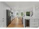 Open kitchen with white cabinets, a large island and wood flooring perfect for entertaining at 10455 Courageous Dr, Indianapolis, IN 46236