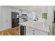 Modern kitchen with stainless steel appliances, wine cooler, white cabinetry, and center island with quartz countertops at 10455 Courageous Dr, Indianapolis, IN 46236