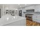 Spacious kitchen with white cabinets, stainless steel appliances, and a large center island at 10455 Courageous Dr, Indianapolis, IN 46236
