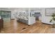 Modern kitchen with wood floors, gray cabinets, and bar stool seating at 10455 Courageous Dr, Indianapolis, IN 46236
