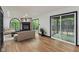 Open-concept living room with fireplace, sliding doors to an outdoor deck, and stylish decor at 10455 Courageous Dr, Indianapolis, IN 46236