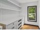 Neat walk-in pantry with custom built-in shelving and drawers with quartz countertops, offers practical storage solutions at 10455 Courageous Dr, Indianapolis, IN 46236
