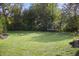 Large backyard with trees surrounding the trampoline at 10599 Geist View Dr, Fishers, IN 46055