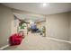 Finished basement area, carpeted with toys and furniture at 10599 Geist View Dr, Fishers, IN 46055