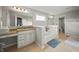 Open bathroom layout with granite countertop vanity and separate bathtub at 10599 Geist View Dr, Fishers, IN 46055