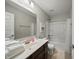 Bathroom featuring a wooden vanity, sink, a toilet, and a bathtub with a shower at 10599 Geist View Dr, Fishers, IN 46055