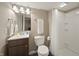 This bathroom features a vanity, toilet, mirror, and shower with a curtain at 10599 Geist View Dr, Fishers, IN 46055