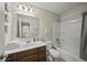 The bathroom features a wooden vanity, a sink, a toilet, and a bathtub with shower at 10599 Geist View Dr, Fishers, IN 46055