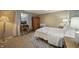 Cozy bedroom with a comfortable bed, decorative rug, and natural light from a window at 10599 Geist View Dr, Fishers, IN 46055