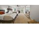 Spacious bedroom featuring two queen beds, soft carpeting, and natural light from multiple windows at 10599 Geist View Dr, Fishers, IN 46055