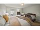 Well-lit bedroom with neutral walls featuring a crib, large window, and soft, cozy carpet at 10599 Geist View Dr, Fishers, IN 46055