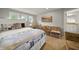 Bright bedroom with a desk, comfortable sitting area, and great natural light from three windows at 10599 Geist View Dr, Fishers, IN 46055