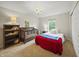 Charming bedroom with a crib and stylish chandelier features a window for natural light at 10599 Geist View Dr, Fishers, IN 46055