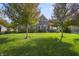 Beautiful home featuring mature trees, lush green lawn, and a well-maintained yard in a quiet neighborhood at 10599 Geist View Dr, Fishers, IN 46055