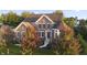 Beautiful brick home featuring a well-manicured lawn, mature trees, and a welcoming front entrance at 10599 Geist View Dr, Fishers, IN 46055