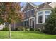 Charming brick home with a well-manicured lawn, mature trees, and a welcoming front entrance at 10599 Geist View Dr, Fishers, IN 46055