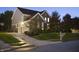 Well-lit home with a two-car garage and inviting driveway, perfect for evening gatherings at 10599 Geist View Dr, Fishers, IN 46055