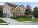 Spacious home with a wide driveway, well-maintained lawn, and mature trees in a quiet neighborhood at 10599 Geist View Dr, Fishers, IN 46055