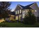 Two-story home with a combination of brick and siding, bathed in the warm glow of twilight at 10599 Geist View Dr, Fishers, IN 46055