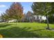 Beautiful home featuring mature trees, lush green lawn, and a well-maintained yard in a quiet neighborhood at 10599 Geist View Dr, Fishers, IN 46055