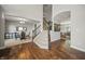 Inviting foyer featuring hardwood floors, staircase, and views into dining and living spaces at 10599 Geist View Dr, Fishers, IN 46055