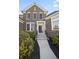 Close up of the facade featuring the front door with a beautiful garden and a pathway leading up to it at 10599 Geist View Dr, Fishers, IN 46055