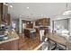Open kitchen featuring a center island, stainless steel appliances, and dark wood cabinetry at 10599 Geist View Dr, Fishers, IN 46055