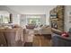 Comfortable living room features a stone fireplace, large windows, and multiple seating areas at 10599 Geist View Dr, Fishers, IN 46055