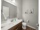 Powder room with wood floors, a modern vanity, and decorative artwork at 10599 Geist View Dr, Fishers, IN 46055