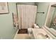 Well lit bathroom features a shower with patterned curtain, a white vanity and framed mirror and gray walls at 10688 Ashview Dr, Fishers, IN 46038