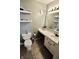 Functional bathroom includes floating shelves, modern fixtures, and a vanity with storage at 10688 Ashview Dr, Fishers, IN 46038