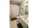 Bathroom with shower with patterned curtain, a white vanity and framed mirror and gray walls at 10688 Ashview Dr, Fishers, IN 46038