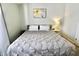 Well-lit bedroom with a comfortable bed, bedside table, and a floral painting at 10688 Ashview Dr, Fishers, IN 46038