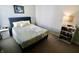 Serene bedroom features soft lighting from the bedside lamp, enhancing the room's cozy and inviting ambiance at 10688 Ashview Dr, Fishers, IN 46038