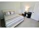 Comfortable bedroom featuring a cozy bed, a vintage desk, a lamp, and a neutral-colored carpet at 10688 Ashview Dr, Fishers, IN 46038