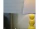 Close-up shot of a yellow bedside lamp and comfortable bed in the primary bedroom at 10688 Ashview Dr, Fishers, IN 46038