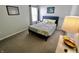 A bright bedroom with a blue bed frame and a bedside table with a lamp illuminating the space at 10688 Ashview Dr, Fishers, IN 46038