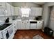 Well-lit kitchen featuring white cabinetry, stainless steel appliances, and a functional layout for meal preparation and enjoyment at 10688 Ashview Dr, Fishers, IN 46038