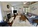 Inviting living room features a cozy fireplace, ceiling fan, and comfortable sectional sofa at 10688 Ashview Dr, Fishers, IN 46038