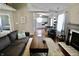Cozy living room featuring a fireplace, plush seating, and open view to the kitchen, perfect for modern living and entertaining at 10688 Ashview Dr, Fishers, IN 46038